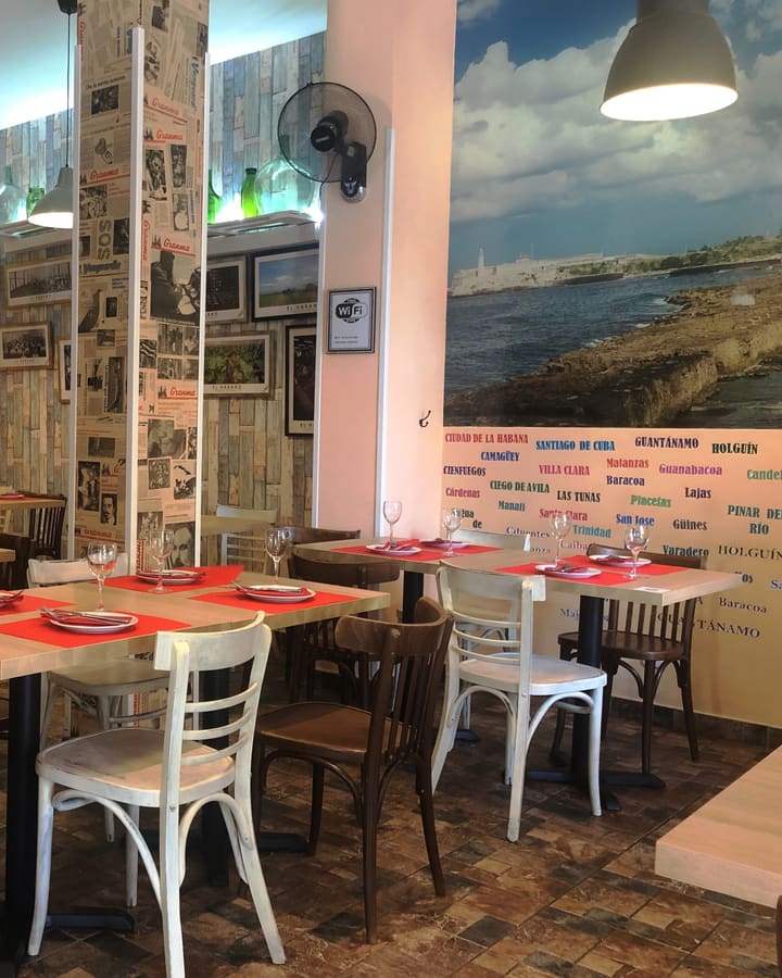 Corner of the dining room with the mural of the Cuban coast and the names of Cuban cities